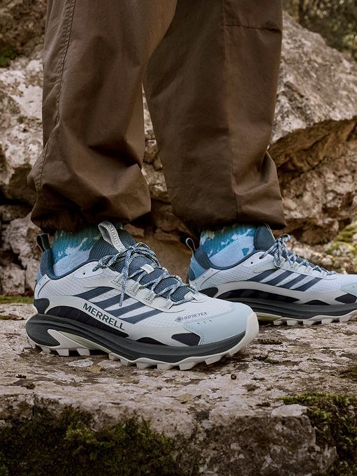 Person wearing Moab Speed 2 GORE-TEX shoes on a rocky trail.